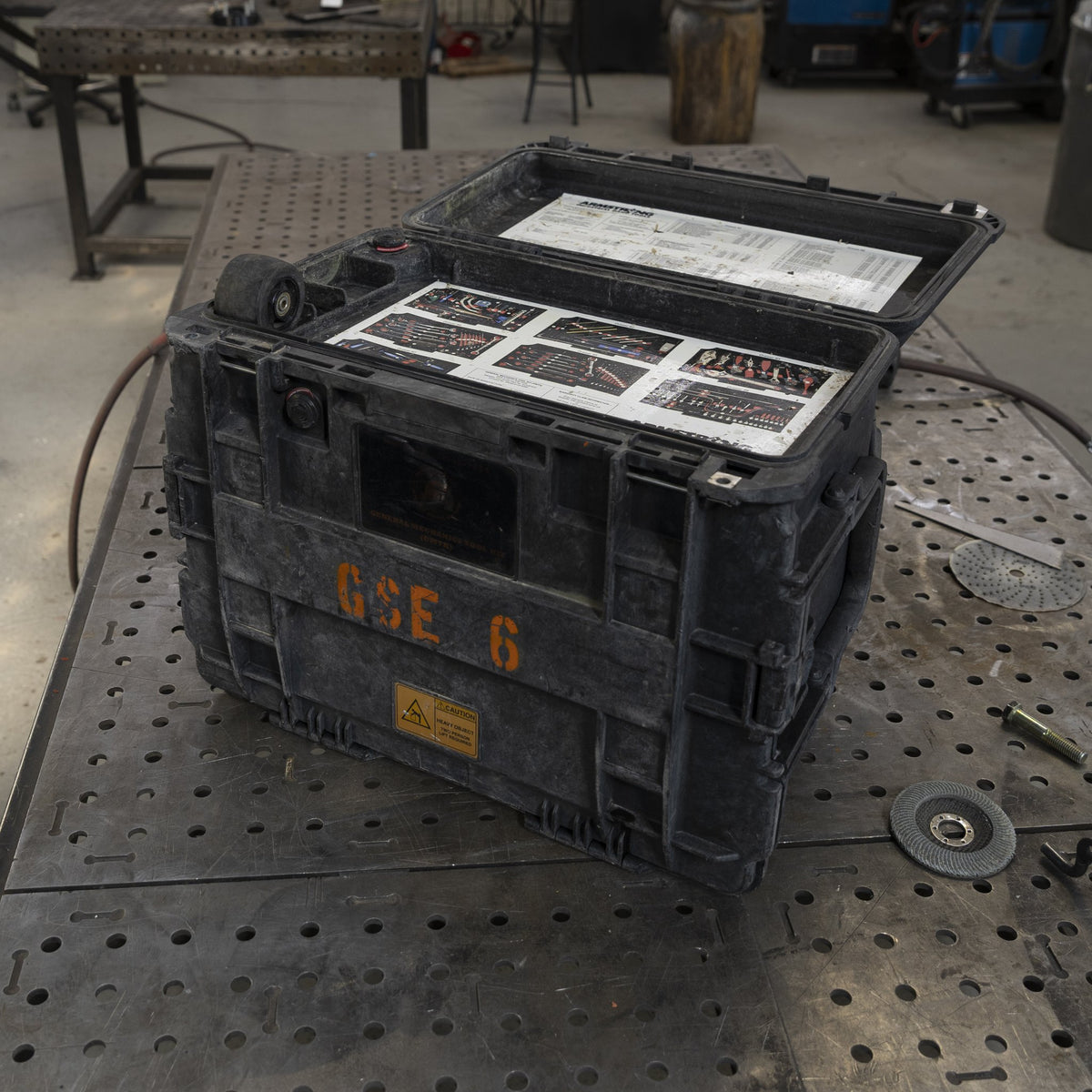 Military tool kit case with lid open showing the contents list