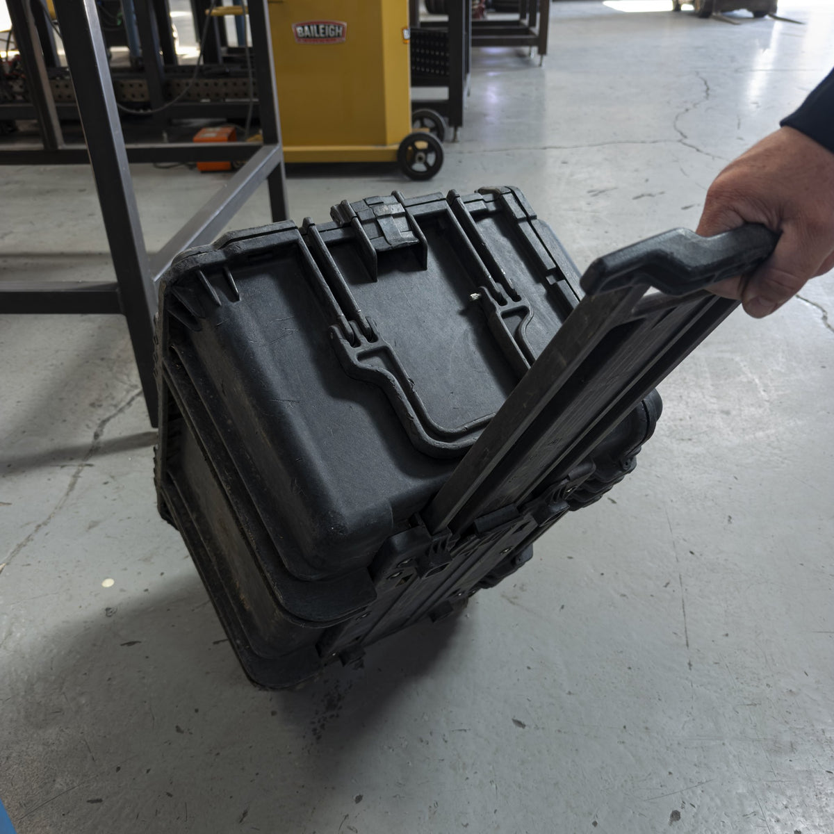 Military tool kit case tilted on its wheels